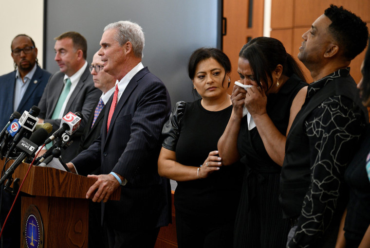 Family members of Enrique Delgado-Garcia attend a news conference by District Attorney Joseph D. Early Jr.