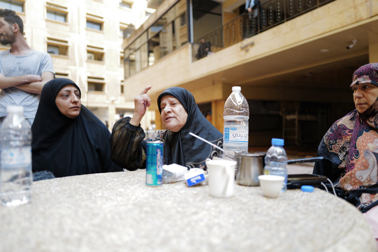 Residents gather following an Israeli airstrike in central Beirut on Monday. 