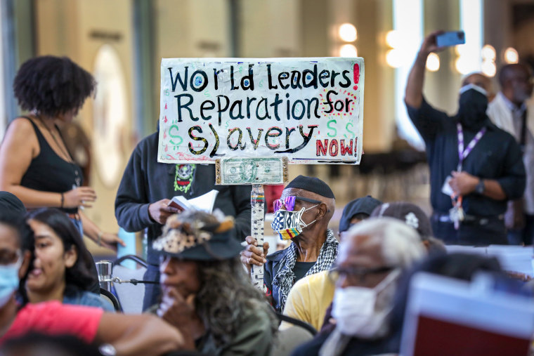 Los Angeles resident holds up a sign.