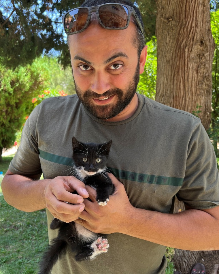 Reuters' journalist Issam Abdallah holding a kitten