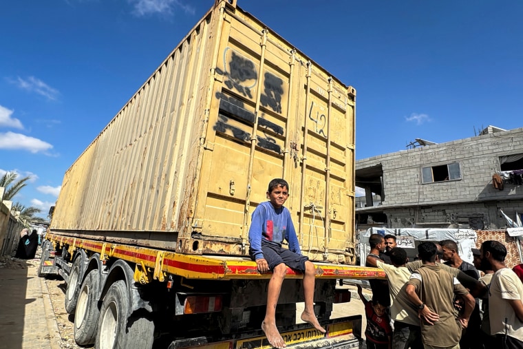 A Palestinian boy sits on a truck