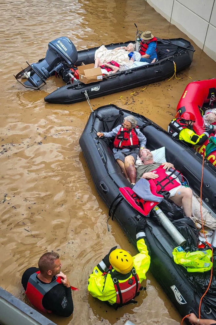 People evacuate Unicoi County Hospital due to unusually high and rising water from the Nolichucky River.