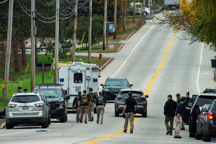 FBI agents work at the scene of a mass shooting at Schemengees Bar