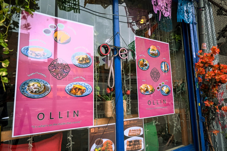 Some of the specialty dishes and menu items at Ollín displayed on the front window.