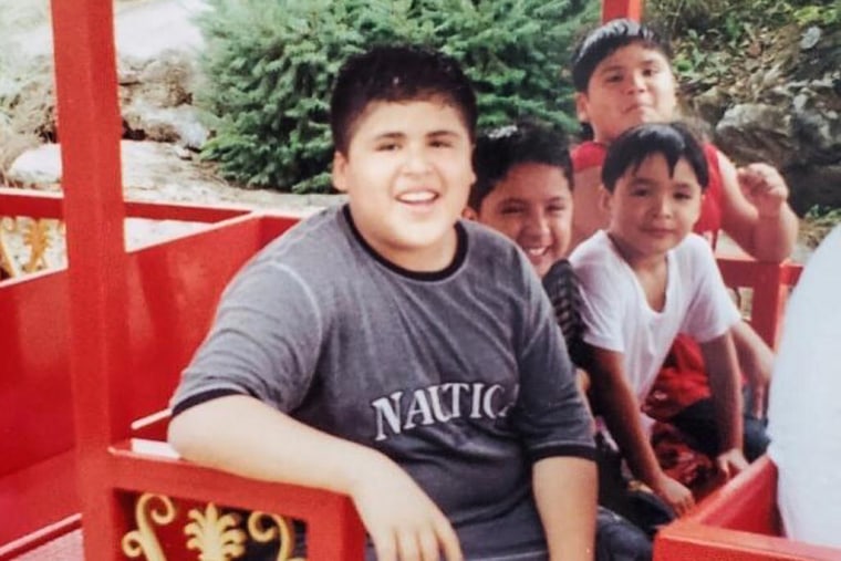 A young Jonathan Perez, center, with his brother and cousins at a theme park