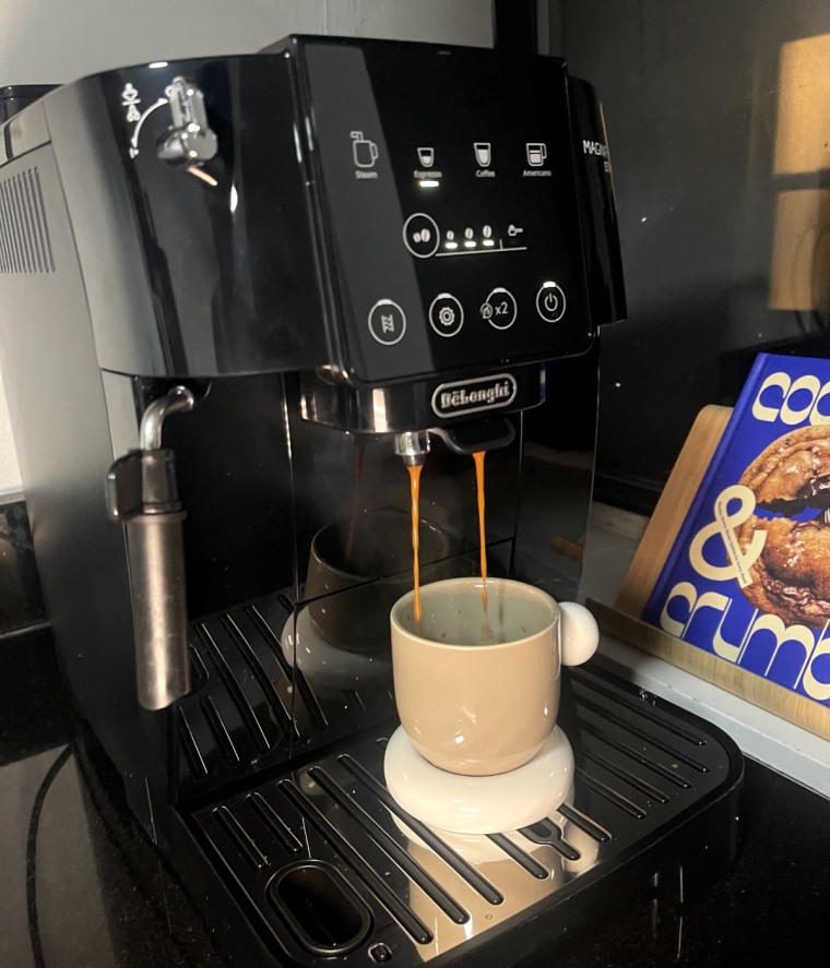 A shot of espresso brews from the De’Longhi Magnifica Start.