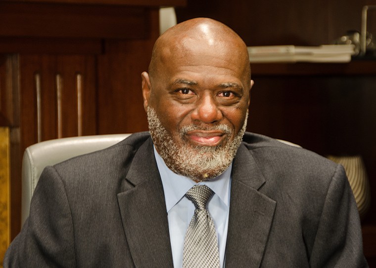 Black man in suit and tie, from the shoulders up 