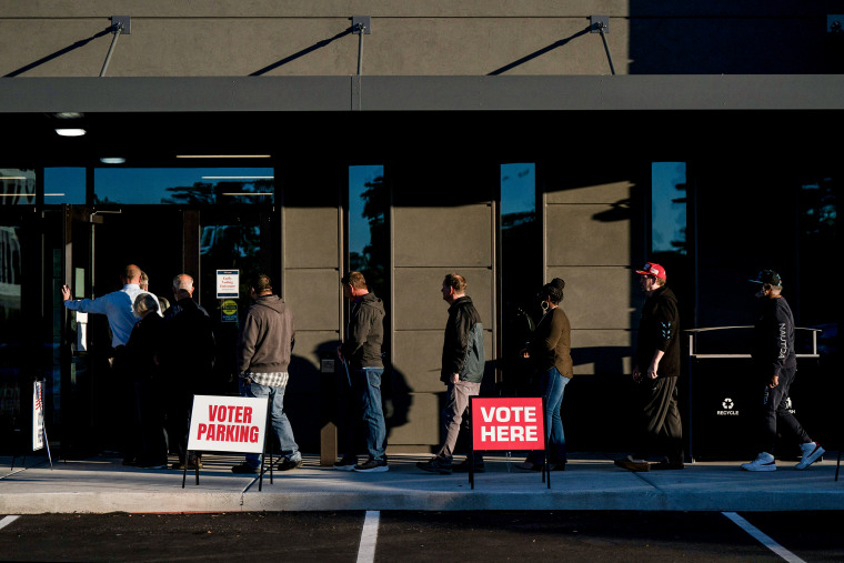 Voters wait in line to cast their ballots on the first day of early voting at a polling station in Wilmington, N.C. on Oct. 17, 2024. 