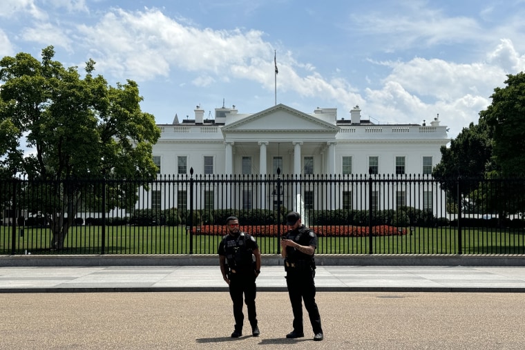 Members of the Secret Service stand outside the White House