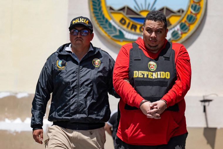 Peruvian police carry out the transfer of one of the members of the Venezuelan-born gang, Tren de Aragua, in Lima on Oct. 5, 2023.