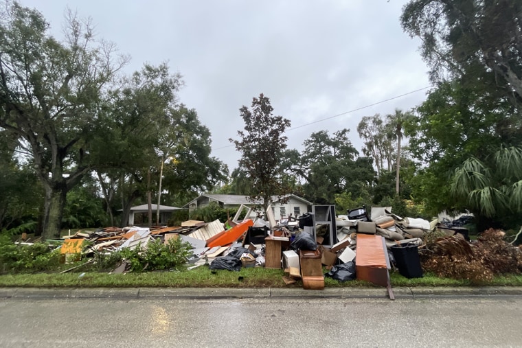 Contents of homes damaged by flooding from Hurricane Helene are piled on the side of the road  in Tampa, Fla., ahead of Hurricane Milton.