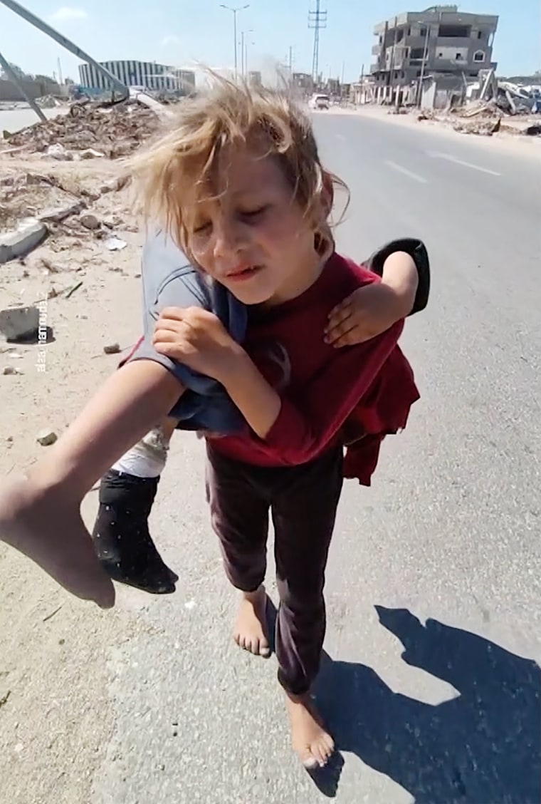 Gaza girl carries injured sister