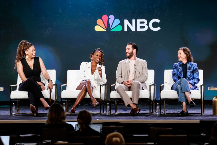 From left, Nkechi Okra Carroll, Shanola Hampton, Mark-Paul Gosselaar, and Kelli Williams sit on stage during a panel