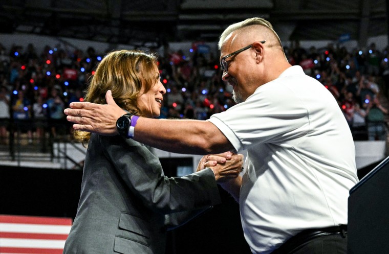 Vice President Kamala Harris is greeted by Bill Carroll, president of the local teamsters