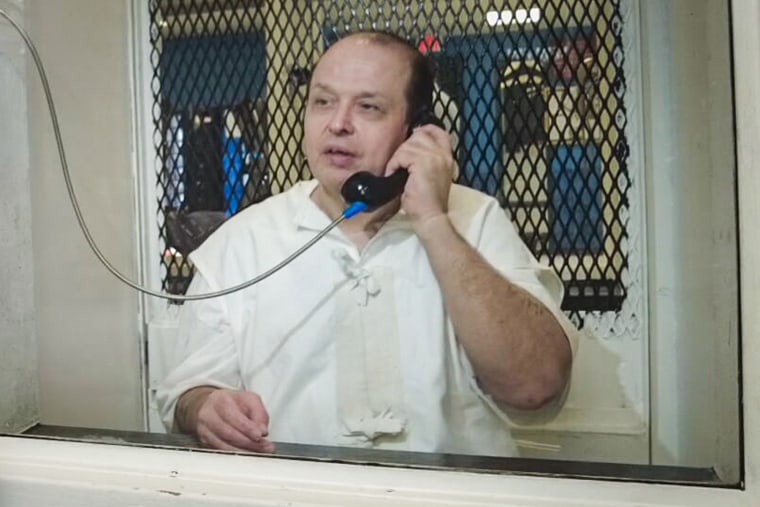 Robert Roberson speaks on the phone in jail