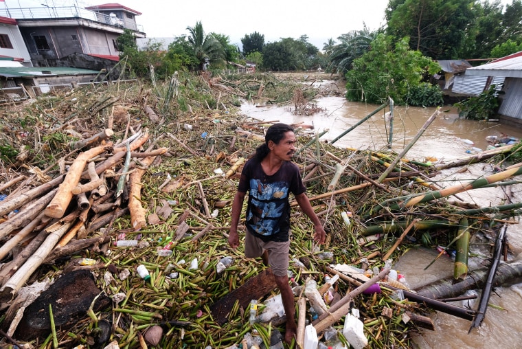 Philippine rescue workers battled floodwaters on October 25 to reach residents still trapped on the roofs of their homes as Tropical Storm Trami moved out to sea after killing at least 40 people. 