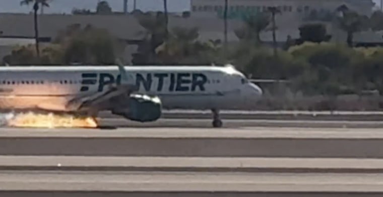 A Frontier flight with flames visible underneath the aircraft at Harry Reid International Airport in Las Vegas.