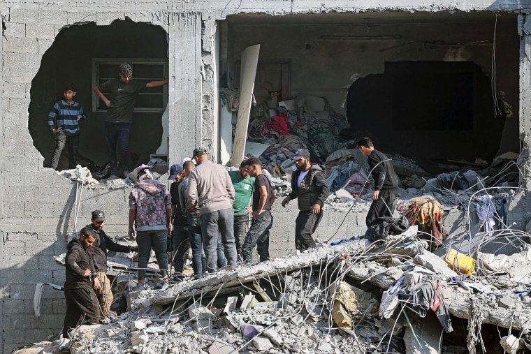 Palestinians check the rubble of a building in the aftermath of an Israeli strike south of Gaza City, on Nov. 22, 2024.