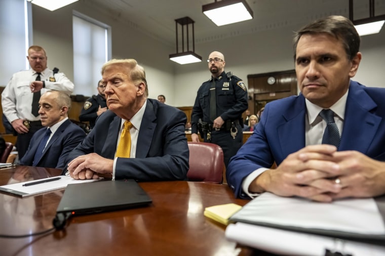 Donald Trump appears in court with attorneys Emil Bove, left, and Todd Blanche, right, for his hush money trial in New York City. 